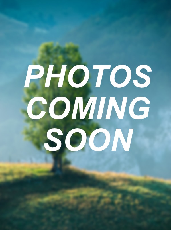 Image placeholder with blurred background of a tree on a grassy hill and the words "Photos Coming Soon" overlaid in white text.